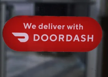 DoorDash Reports Record Earnings and Expands into New Markets - AP Photo/Charles Krupa, File
