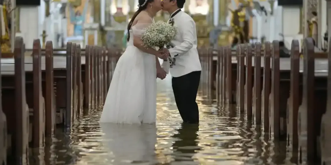 Typhoon Wipha Can’t Stop This Wedding: A Flooded Ceremony in the Philippines - AP Photo/Aaron Favila