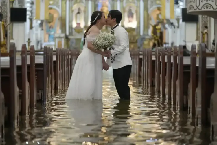 Typhoon Wipha Can’t Stop This Wedding: A Flooded Ceremony in the Philippines - AP Photo/Aaron Favila
