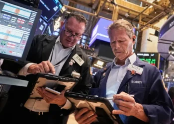 Wall Street eases as stocks retreat from record highs; Fed Chair warns valuations are stretched while gold prices set new records. - AP Photo/Richard Drew