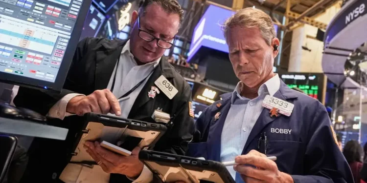 Wall Street eases as stocks retreat from record highs; Fed Chair warns valuations are stretched while gold prices set new records. - AP Photo/Richard Drew