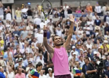 Alcaraz overpowers Djokovic 6-4, 7-6, 6-2 at U.S. Open semifinal, advancing to third straight major final in dominant performance. - AP Photo/Seth Wenig