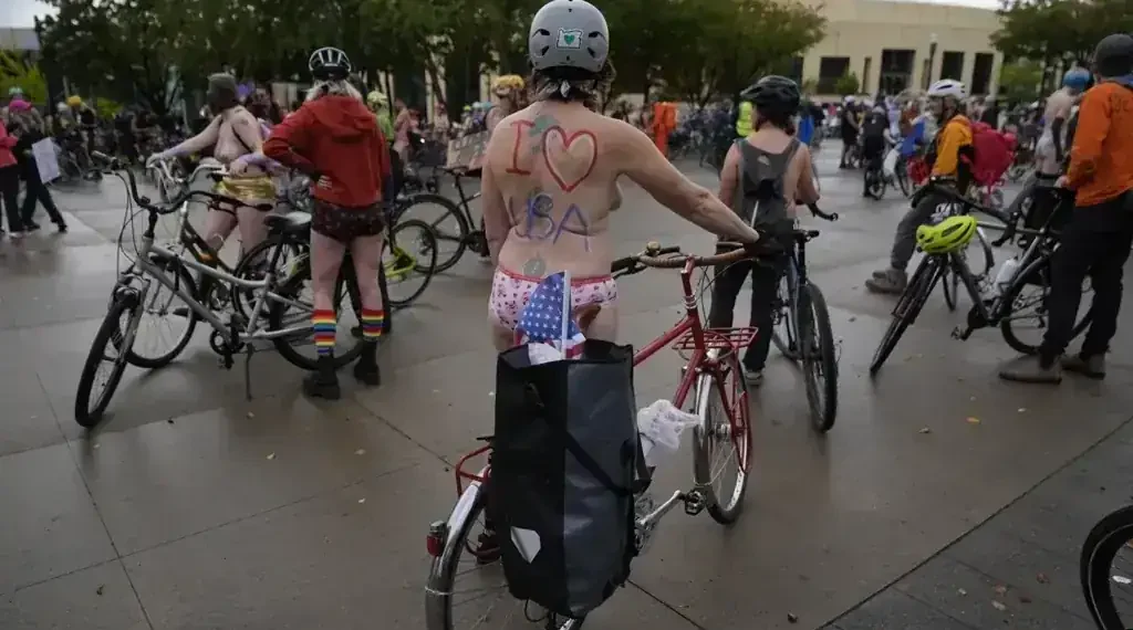 Portland Protesters Stage Naked Bike Ride to Oppose Federal Troop Deployment - AP Photo/Jenny Kane