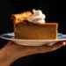Tall deep-dish pumpkin pie sliced on table with skillet - Alanna Hale/Voracious via AP