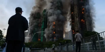 Fire crews battle smoke at burning Hong Kong high-rise residential towers - AP Photo/Chan Long Hei