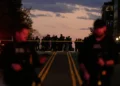 National Guard officers stand near security barriers in Washington - AP Photo/Mark Schiefelbein