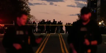 National Guard officers stand near security barriers in Washington - AP Photo/Mark Schiefelbein
