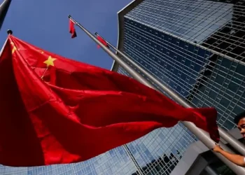 Beijing skyline with Chinese flag representing economic policy planning - Photo: Reuters/Maxim Shemetov/CNA