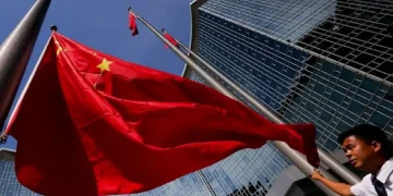 Beijing skyline with Chinese flag representing economic policy planning - Photo: Reuters/Maxim Shemetov/CNA