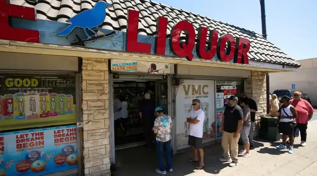 Winning Powerball and Mega Millions tickets stacked on a table - AP Photo/Damian Dovarganes, File