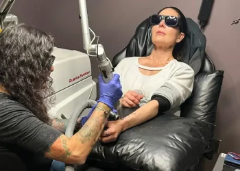 Laser tattoo removal procedure on forearm in professional studio - AP Photo/Corey Williams