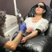 Laser tattoo removal procedure on forearm in professional studio - AP Photo/Corey Williams