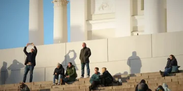 Nordic people embracing winter light rituals outdoors - AP Photo/Sergei Grits
