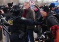 Minnesota ICE shooting scene with police vehicles and protesters - AP Photo/Adam Bettcher