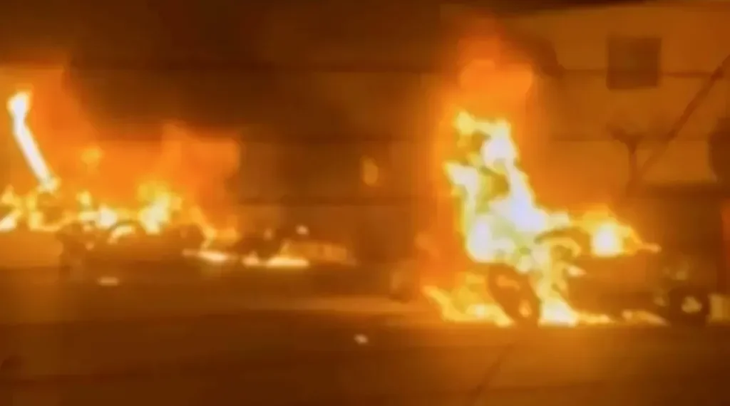 Iranian protesters gather at night amid internet shutdown - Iran state TV via AP