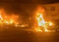 Iranian protesters gather at night amid internet shutdown - Iran state TV via AP