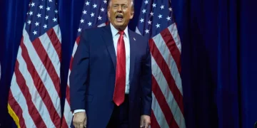 Venezuelan oil barrels with U.S. and Venezuela flags - AP Photo/Evan Vucci