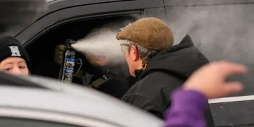 Federal agents and protesters during Minneapolis immigration arrest - AP Photo/John Locher