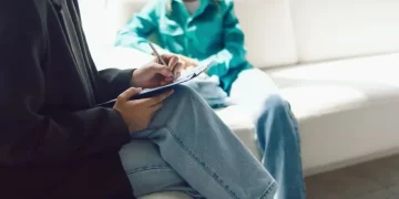 Diagnostic manual psychiatry book representing mental health classification - Olga Pankova/Moment RF/Getty Images