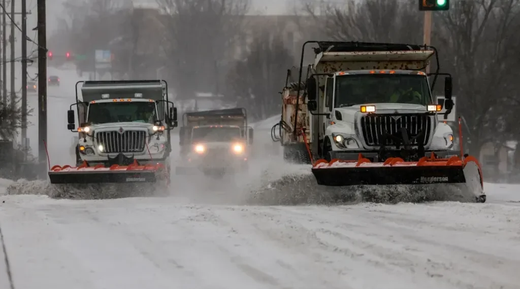 Snow-covered airport runway during U.S. winter storm disruptions - Mike Simons/Tulsa World via AP