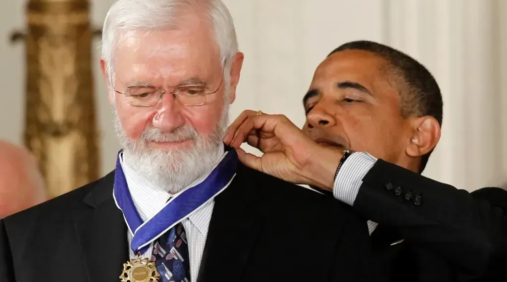 Dr. William Foege, smallpox eradication pioneer, smiling at public health event - AP Photo/Charles Dharapak, File