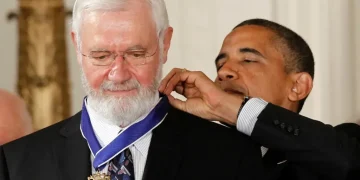 Dr. William Foege, smallpox eradication pioneer, smiling at public health event - AP Photo/Charles Dharapak, File