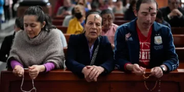 Ash cross and Ramadan lantern symbolizing fasting seasons - AP Photo/Fernando Vergara, File