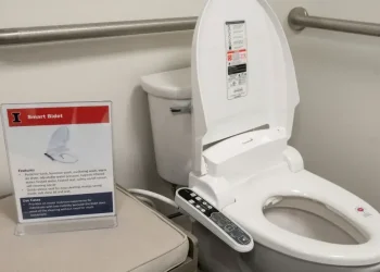 Bidet attachment on toilet illustrating water cleansing after bathroom use - Robin Scholz/The News-Gazette via AP, File