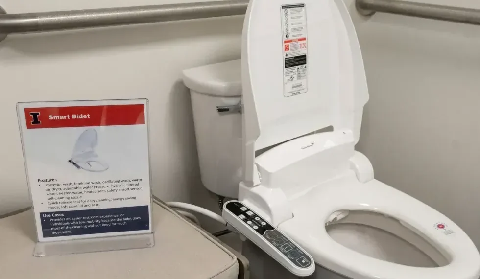 Bidet attachment on toilet illustrating water cleansing after bathroom use - Robin Scholz/The News-Gazette via AP, File