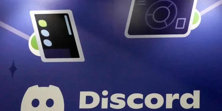 Discord app logo displayed on smartphone screen - AP Photo/Jeff Chiu, File