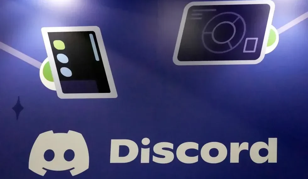 Discord app logo displayed on smartphone screen - AP Photo/Jeff Chiu, File