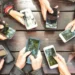 Smartphone showing active group chat messages with icons - Photo by View Apart/Canva