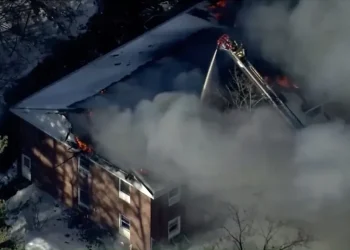 Flames and smoke rise from a collapsed Nashua mental health facility - WCVB-TV via AP