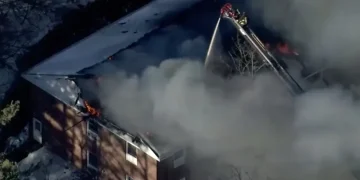 Flames and smoke rise from a collapsed Nashua mental health facility - WCVB-TV via AP