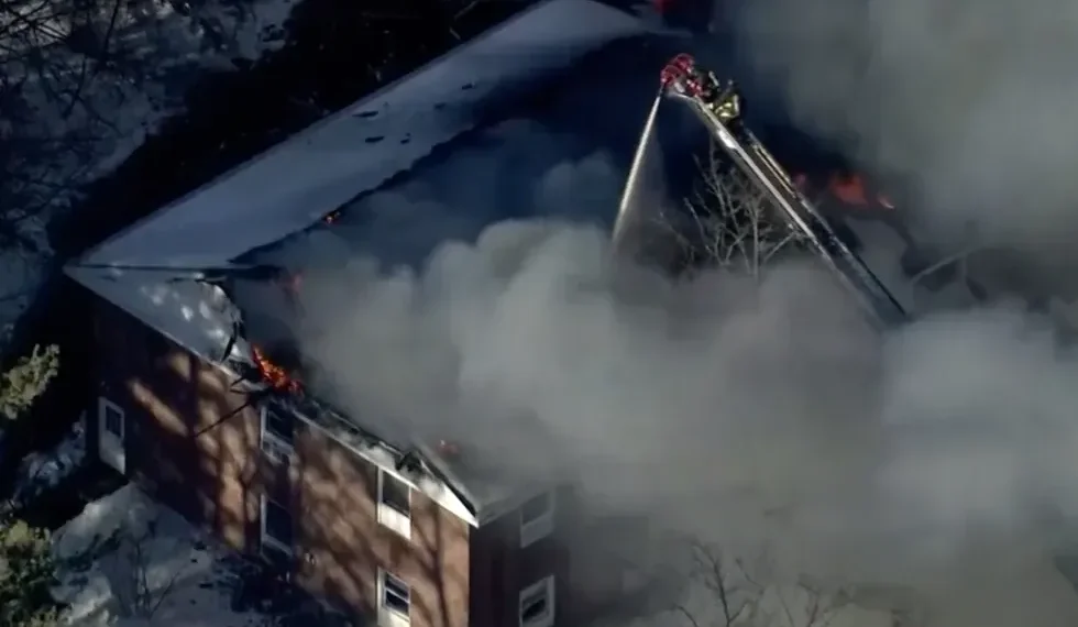 Flames and smoke rise from a collapsed Nashua mental health facility - WCVB-TV via AP