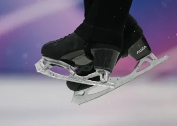 Olympic figure skater landing jump on hard ice - AP Photo/Ashley Landis