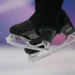 Olympic figure skater landing jump on hard ice - AP Photo/Ashley Landis