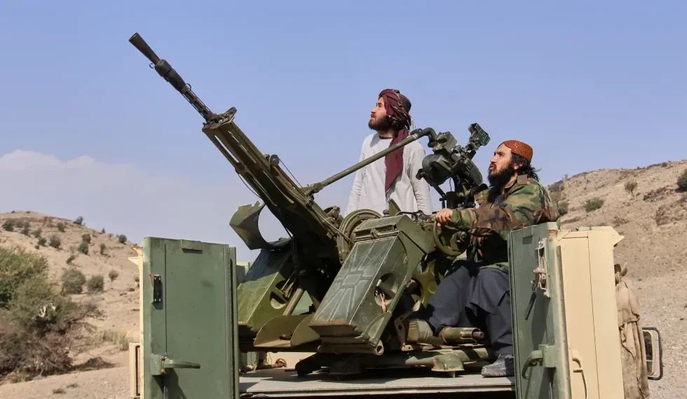 Pakistani and Afghan border forces after cross-border strikes - AP Photo/Saifullah Zahir