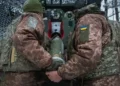 Ukrainian soldiers in trench amid drone surveillance- AP Photo/Andrii Marienko, File