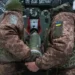 Ukrainian soldiers in trench amid drone surveillance- AP Photo/Andrii Marienko, File