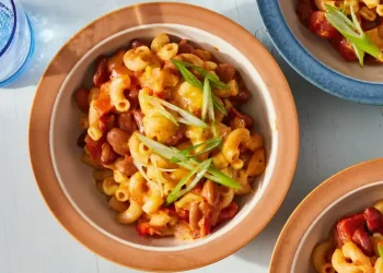 Bowl of slow cooker chili mac topped with cheese and green onions - Kristin Teig/Voracious via AP