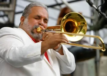 Willie Colón performing with trombone on stage - AP Photo/Jacquelyn Martin, File