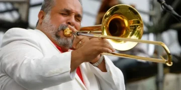 Willie Colón performing with trombone on stage - AP Photo/Jacquelyn Martin, File
