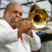 Willie Colón performing with trombone on stage - AP Photo/Jacquelyn Martin, File