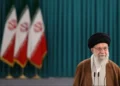 Iranian leaders’ portraits and Tehran skyline at sunset - Majid Asgaripour/Wana News Agency/Reuters