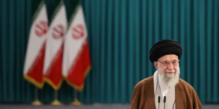 Iranian leaders’ portraits and Tehran skyline at sunset - Majid Asgaripour/Wana News Agency/Reuters