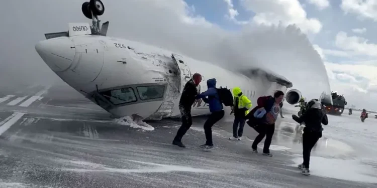 Overturned Delta regional jet on Toronto runway after landing failure - Peter Koukov/Handout/Reuters