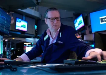 Oil barrels and global market charts reflecting rising crude prices - AP Photo/Seth Wenig