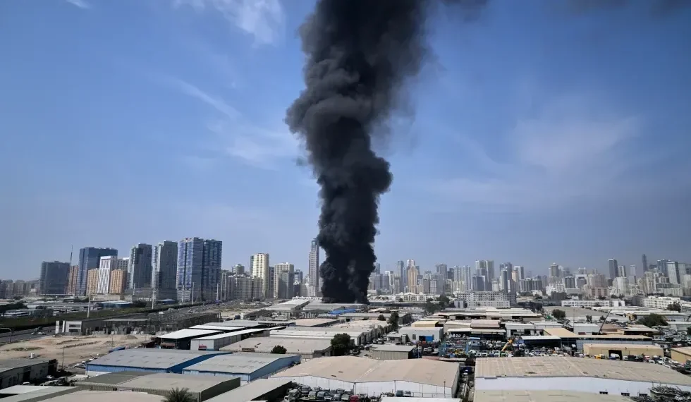 Smoke rises near Dubai skyline after missile interceptions - AP Photo/Altaf Qadri