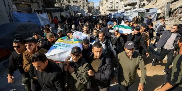 Hamas supporters carry coffins during funeral rally for commander killed in Gaza - REUTERS/Dawoud Abu Alkas